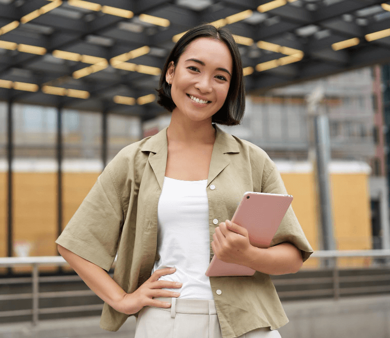 A woman her tablet while smiling